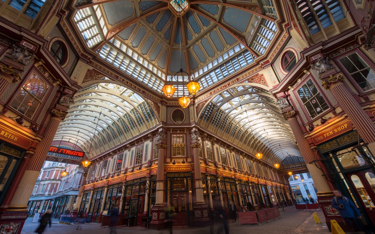 Leadenhall Market in London with ornate ceiling and bustling shops.