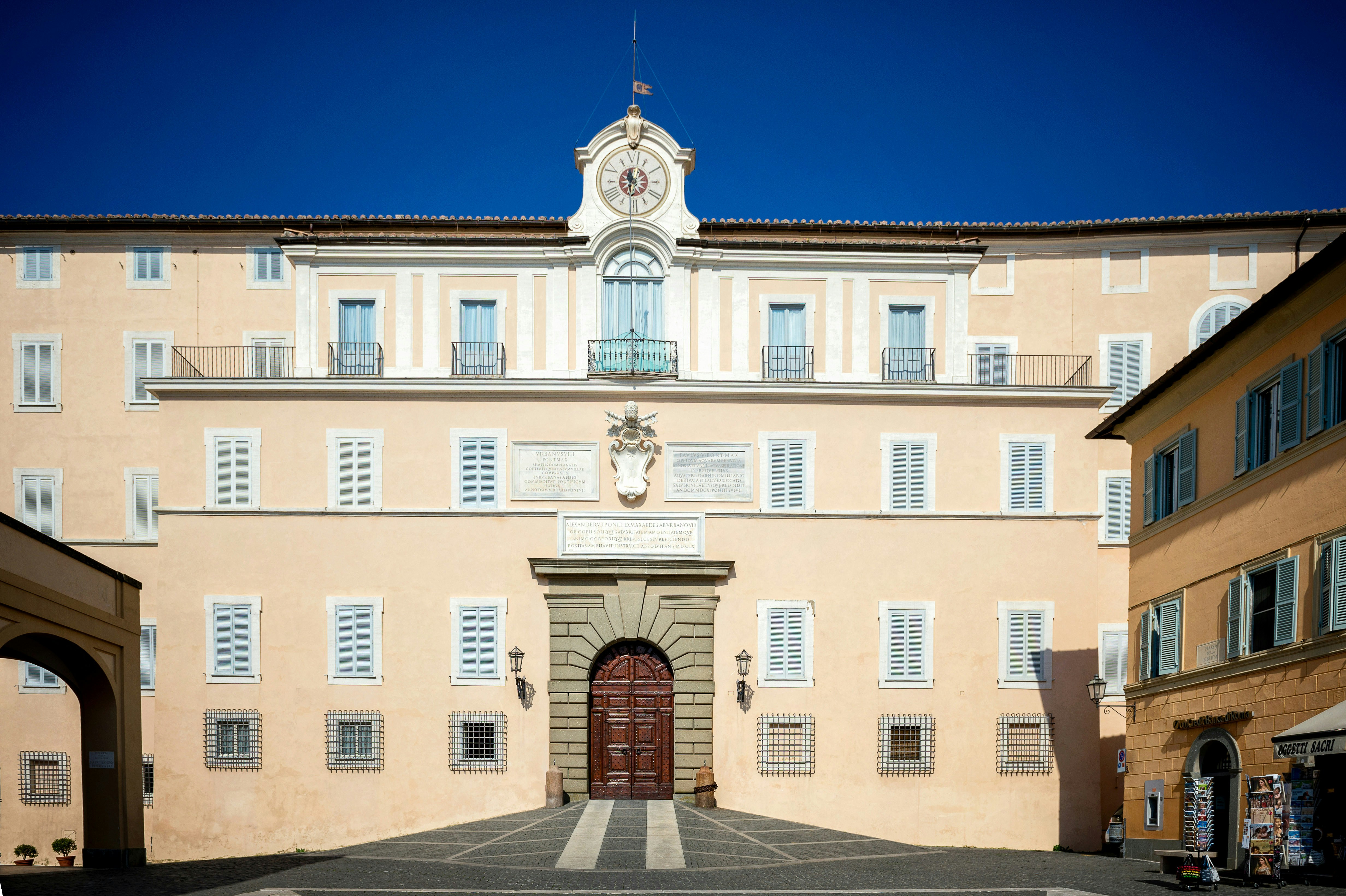 Apostolic Palace of Castel Gandolfo with scenic gardens in the background, Italy.