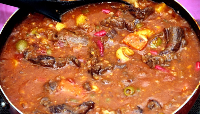 Fricandó dish with mushrooms and sauce served on a white plate, traditional Spanish cuisine.