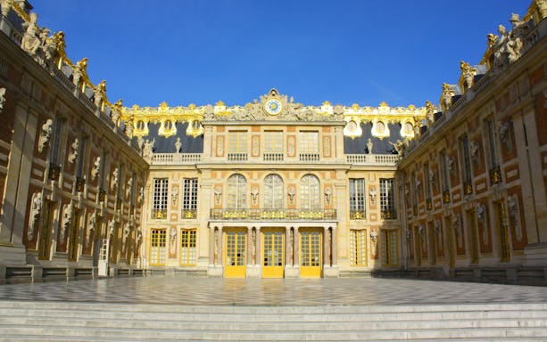 Carrosses Gallery at Versailles Palace showcasing historic royal carriages.