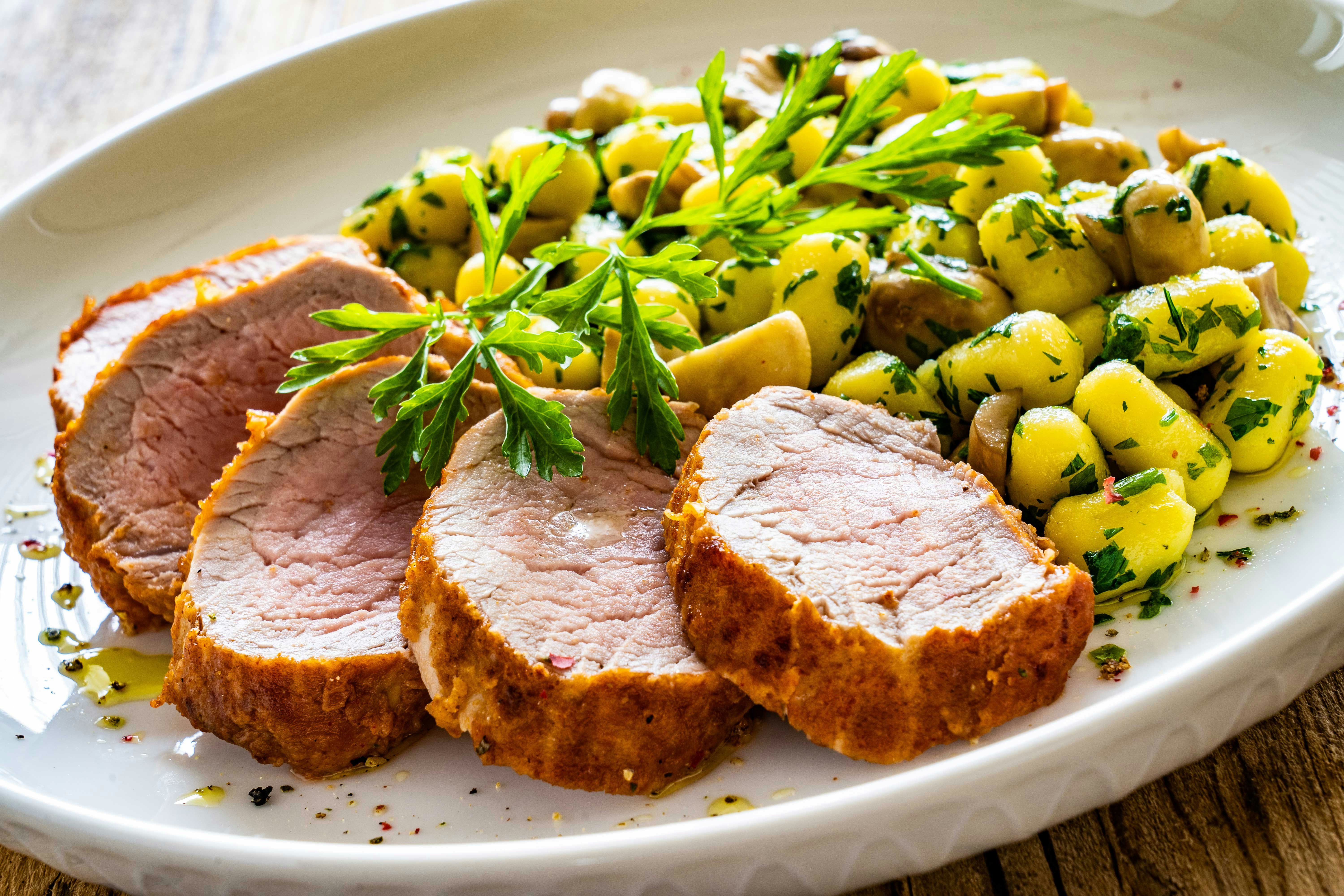 Sliced pork tenderloin with gnocchi and herbs, Florence restaurant Christmas menu.