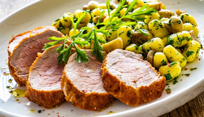 Sliced pork tenderloin with gnocchi and herbs