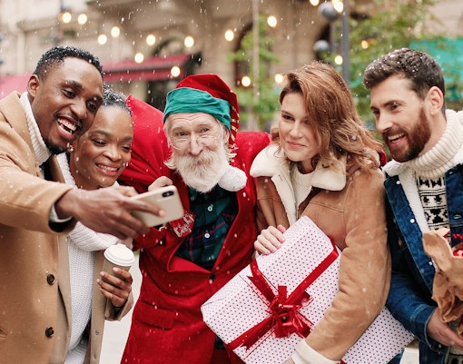 Group taking selfie with Santa Claus during Christmas in Melbourne.