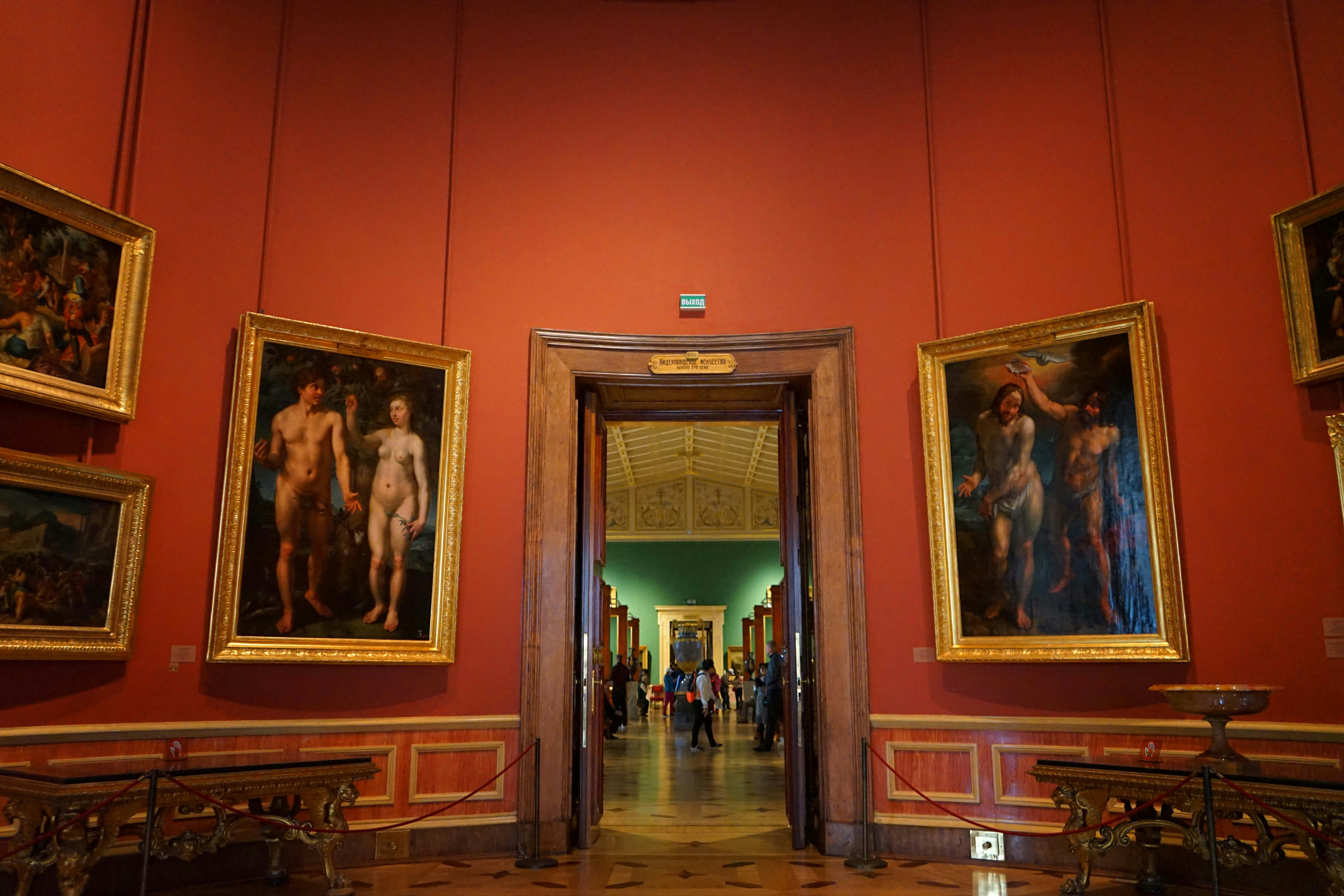 Interior view of Uffizi Gallery with classic paintings and visitors in Florence, Italy.