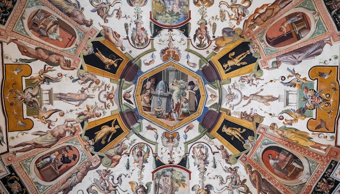 Intricate ceiling fresco at Uffizi Gallery, a tapestry of mythological scenes and vibrant Renaissance artistry drawing eyes upward