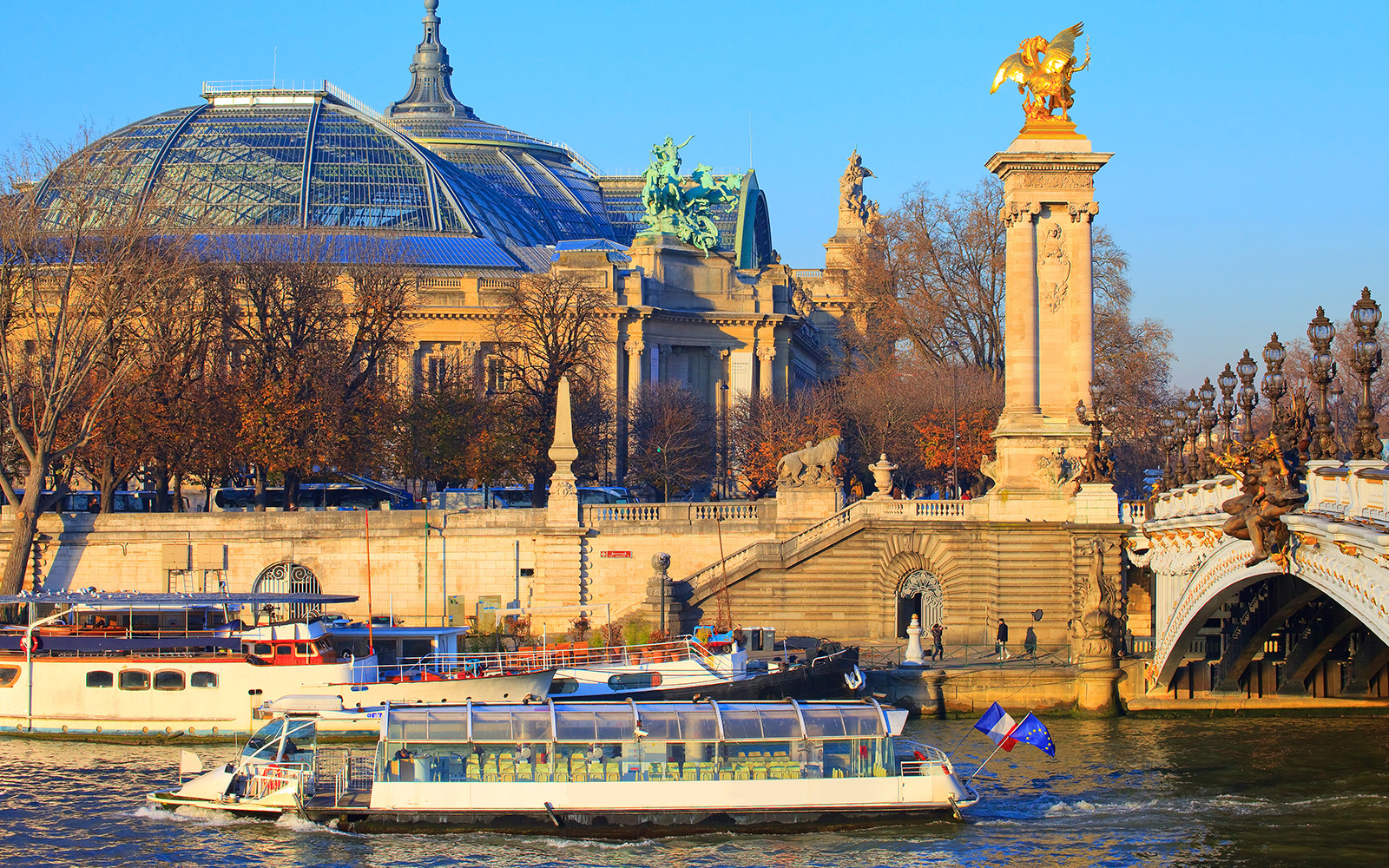 Batobus ferry cruising on the Seine River with Eiffel Tower in the background, Paris.