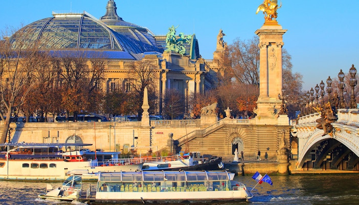 Batobus ferry cruising on the Seine River with Eiffel Tower in the background, Paris.