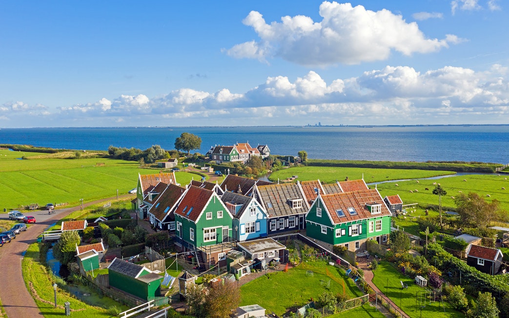 Traditional Dutch houses near the sea in Marken, part of Volendam Cheese Factory Tours.