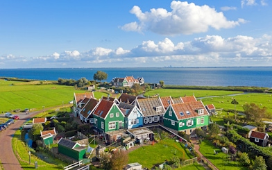 Traditional Dutch houses near the sea in Marken, part of Volendam Cheese Factory Tours.