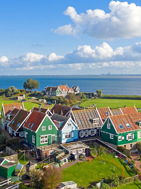 Traditional Dutch houses near the sea in Marken, part of Volendam Cheese Factory Tours.