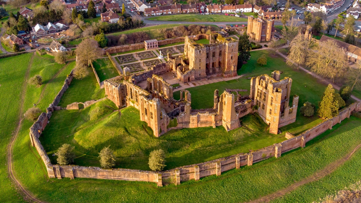 Kenilworth Castle ruins with lush green landscape in Warwickshire, England.