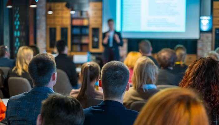 KBr Photography Center exhibition hall with visitors viewing displayed photographs.