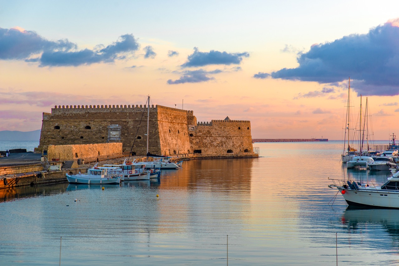Koules Fortress at sunset with boats in Heraklion, Crete.