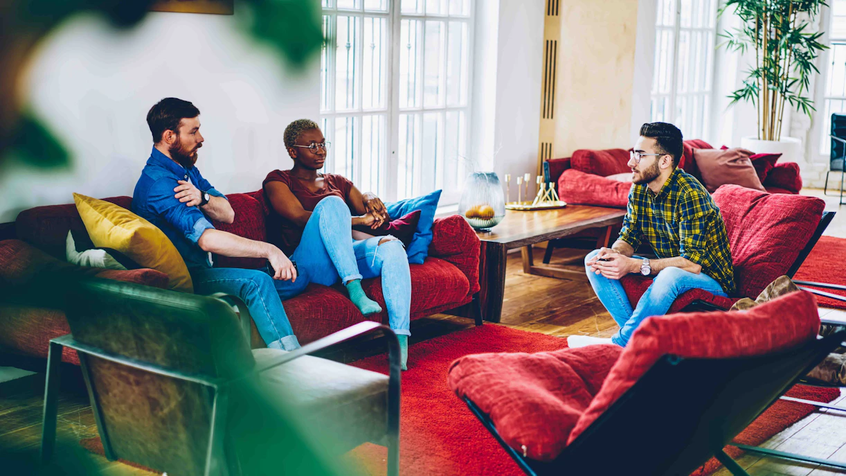 Group of people relaxing in a cozy room.
