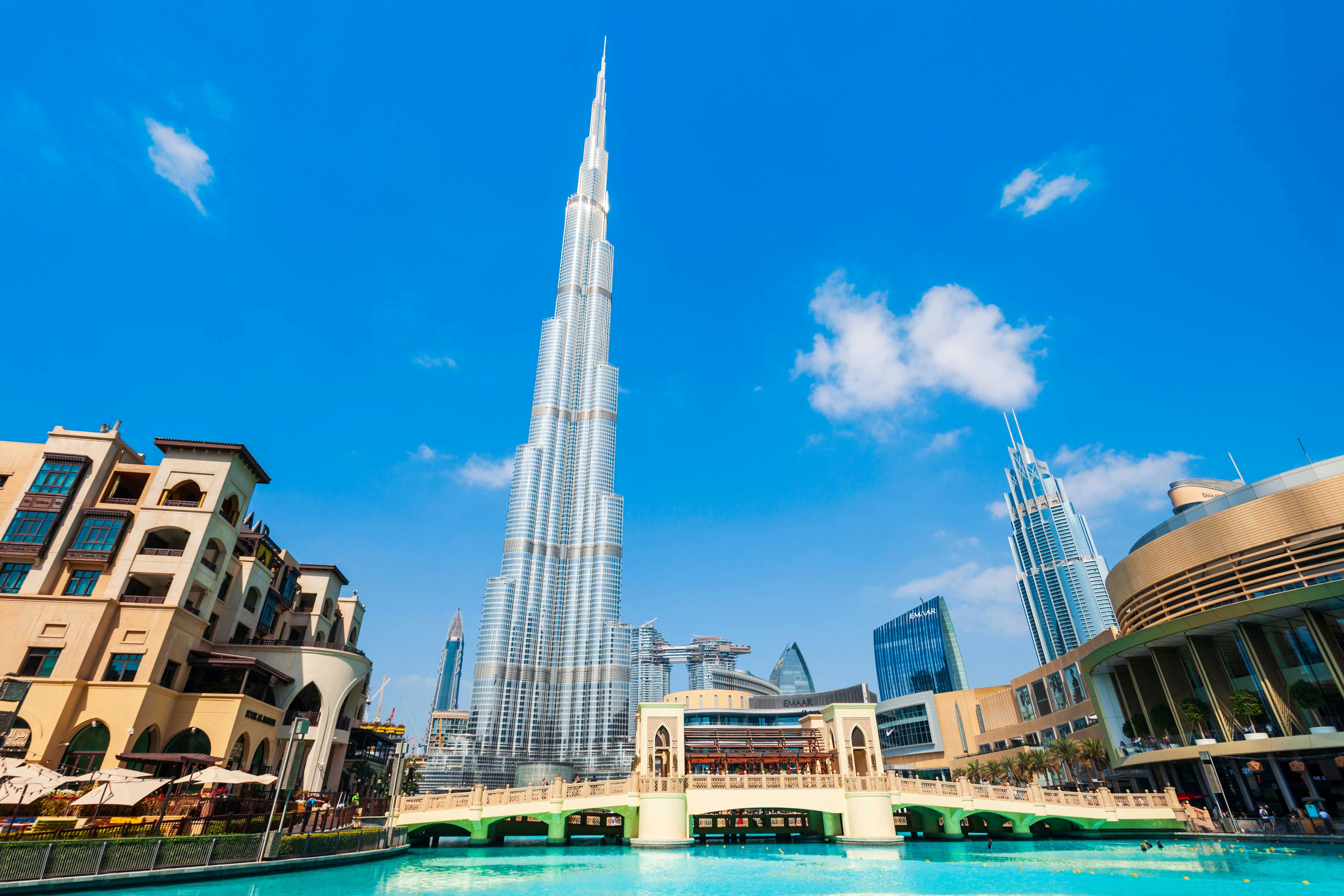 Burj Khalifa towering over Dubai cityscape with surrounding modern architecture.