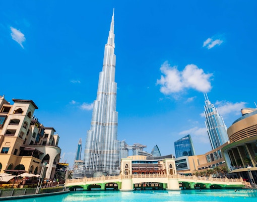 Burj Khalifa towering over Dubai cityscape with surrounding modern architecture.