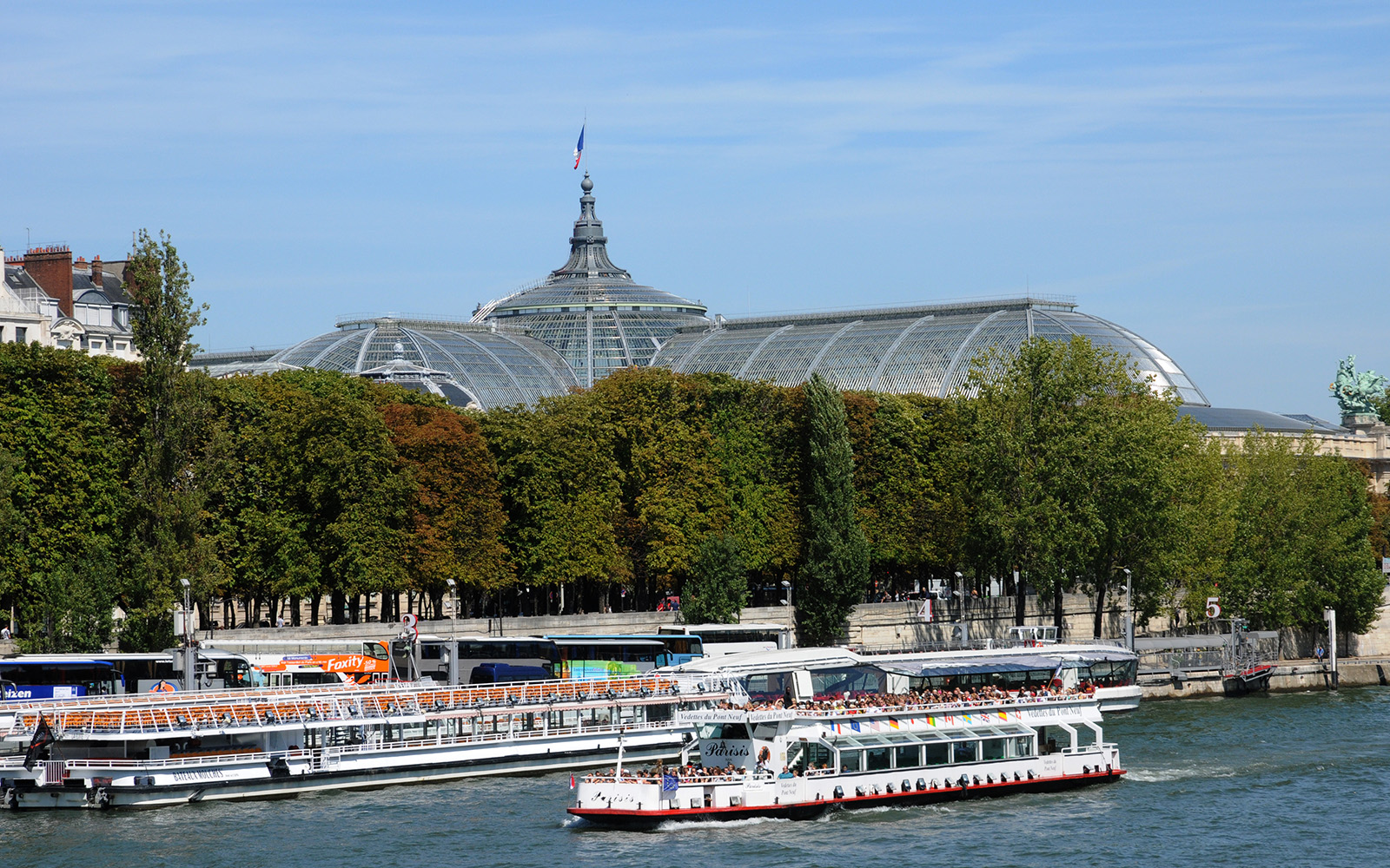 Seine River cruise with Bateaux Mouches, Paris landmarks in view.