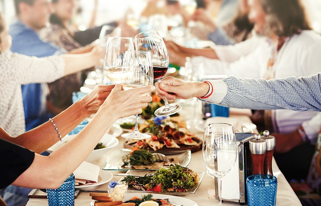 Toasting wine glasses at a festive New Year’s Eve dinner in Amsterdam.