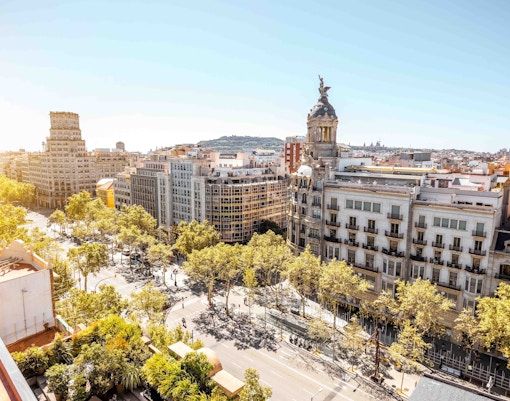 Aerial view of Passeig de Gracia in Barcelona, showcasing historic buildings and tree-lined streets.