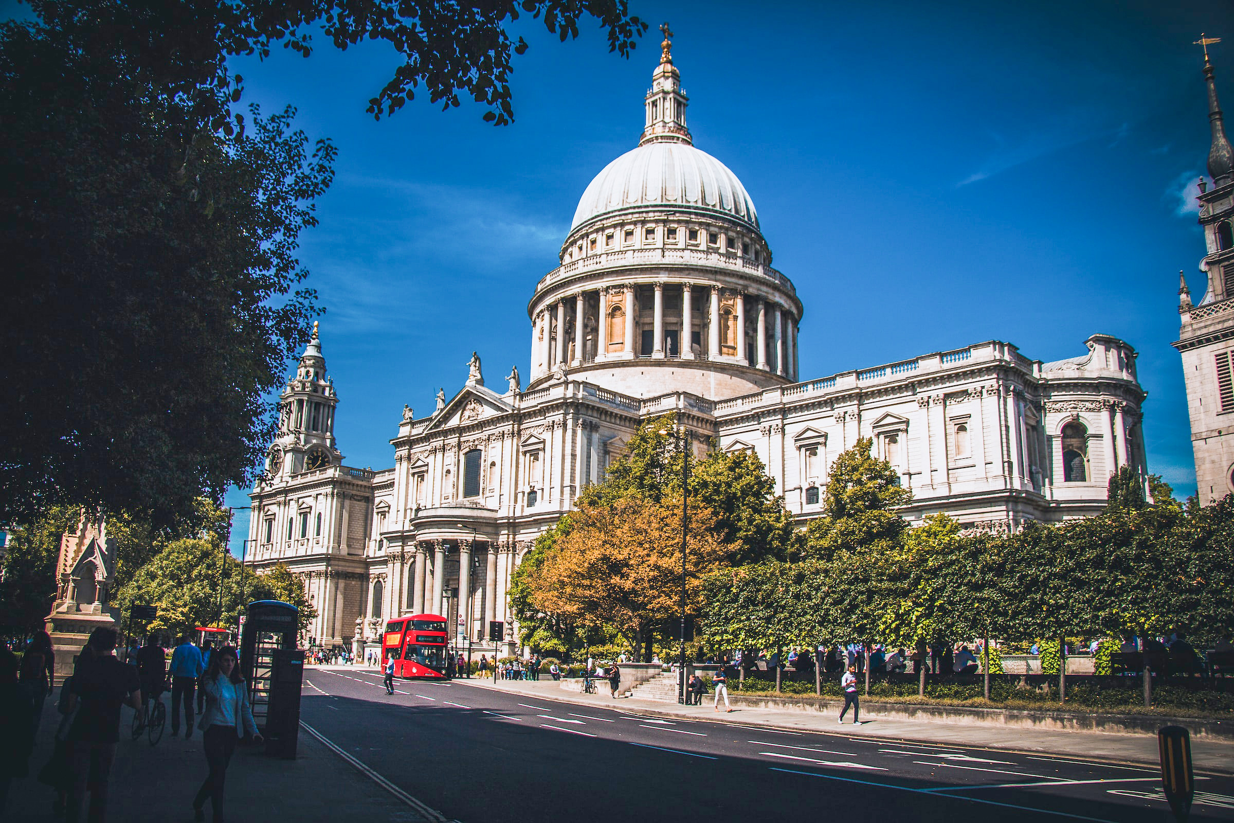 St Paul's Cathedral in London with red double-decker bus passing by.