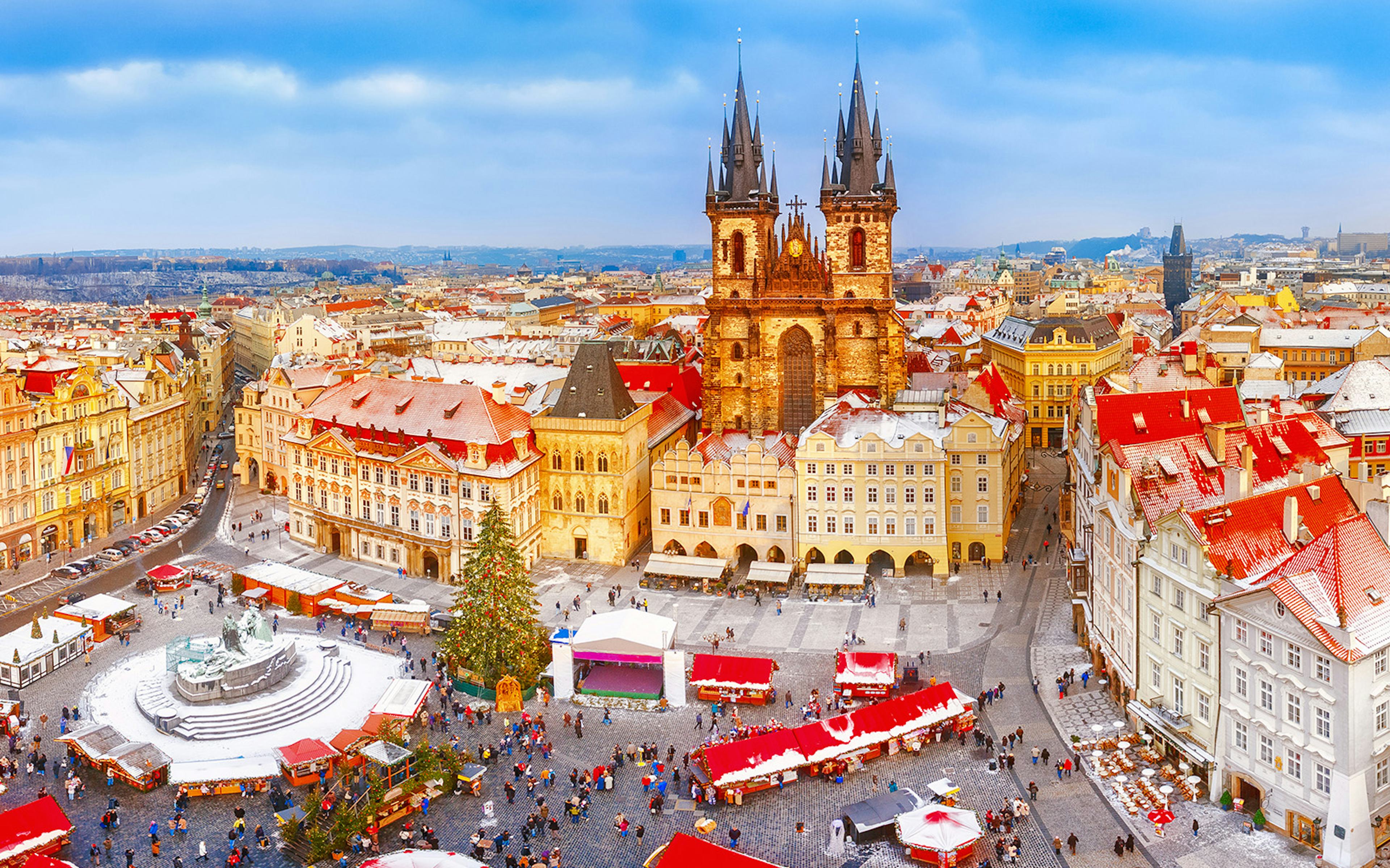 Prague Old Town Square with Christmas market and Tyn Church in winter.