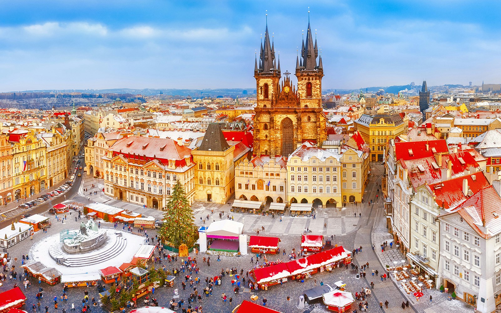 Prague Old Town Square with Christmas market and Tyn Church in winter.