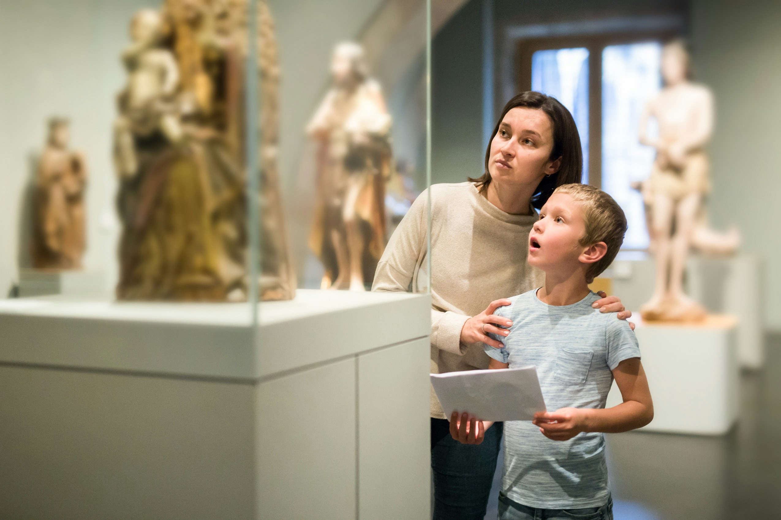 Mother and child observing sculptures at Museo di Scultura Antica Giovanni Barracco, Rome.