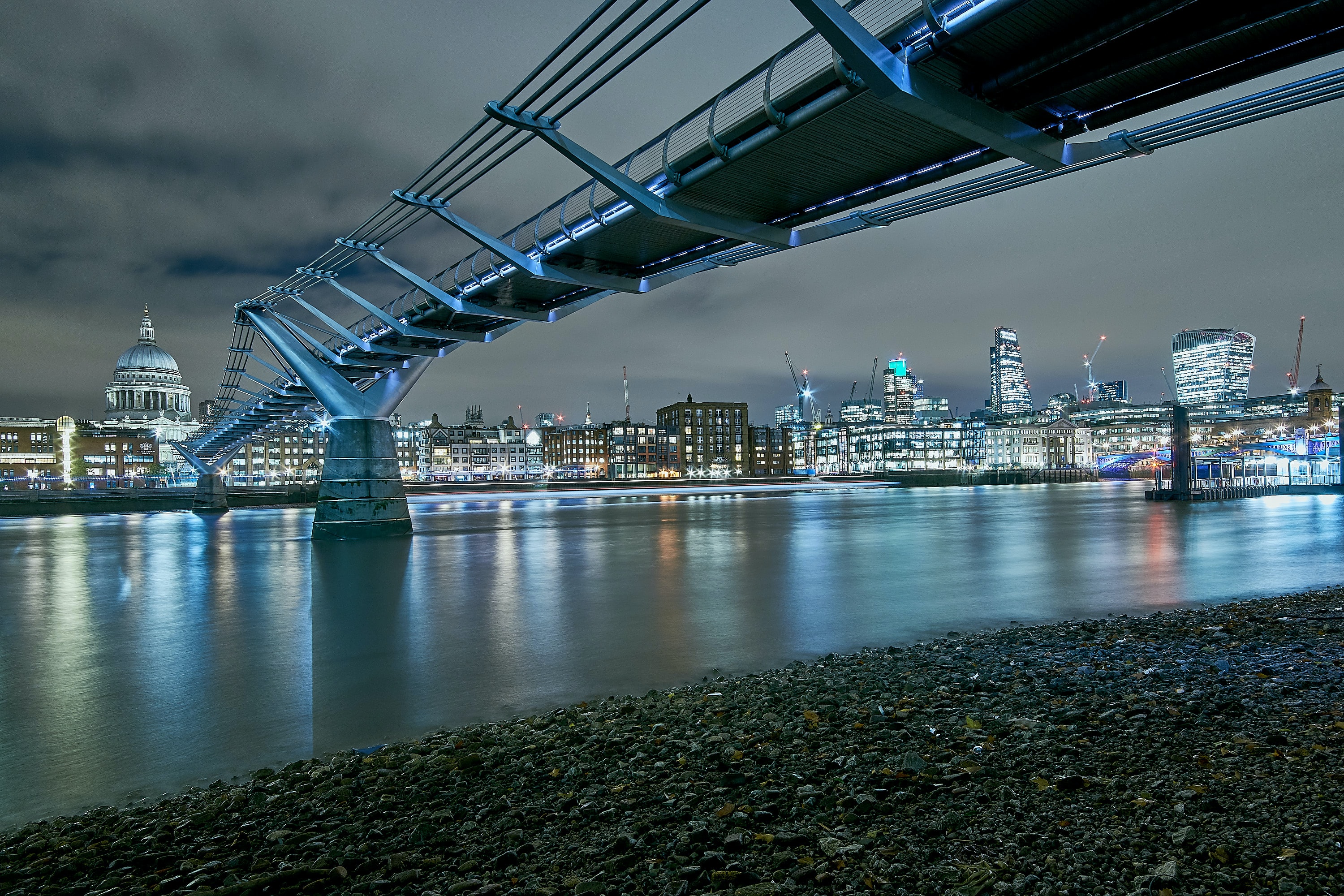 Millennium Bridge spanning the Thames River with St. Paul's Cathedral in the background, London.