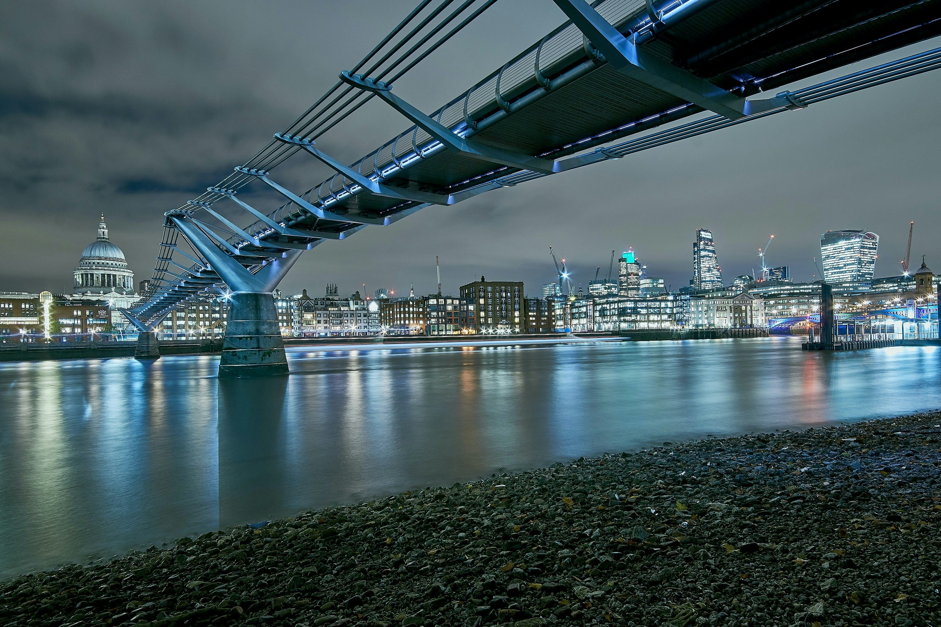 Millennium Bridge spanning the Thames River with St. Paul's Cathedral in the background, London.