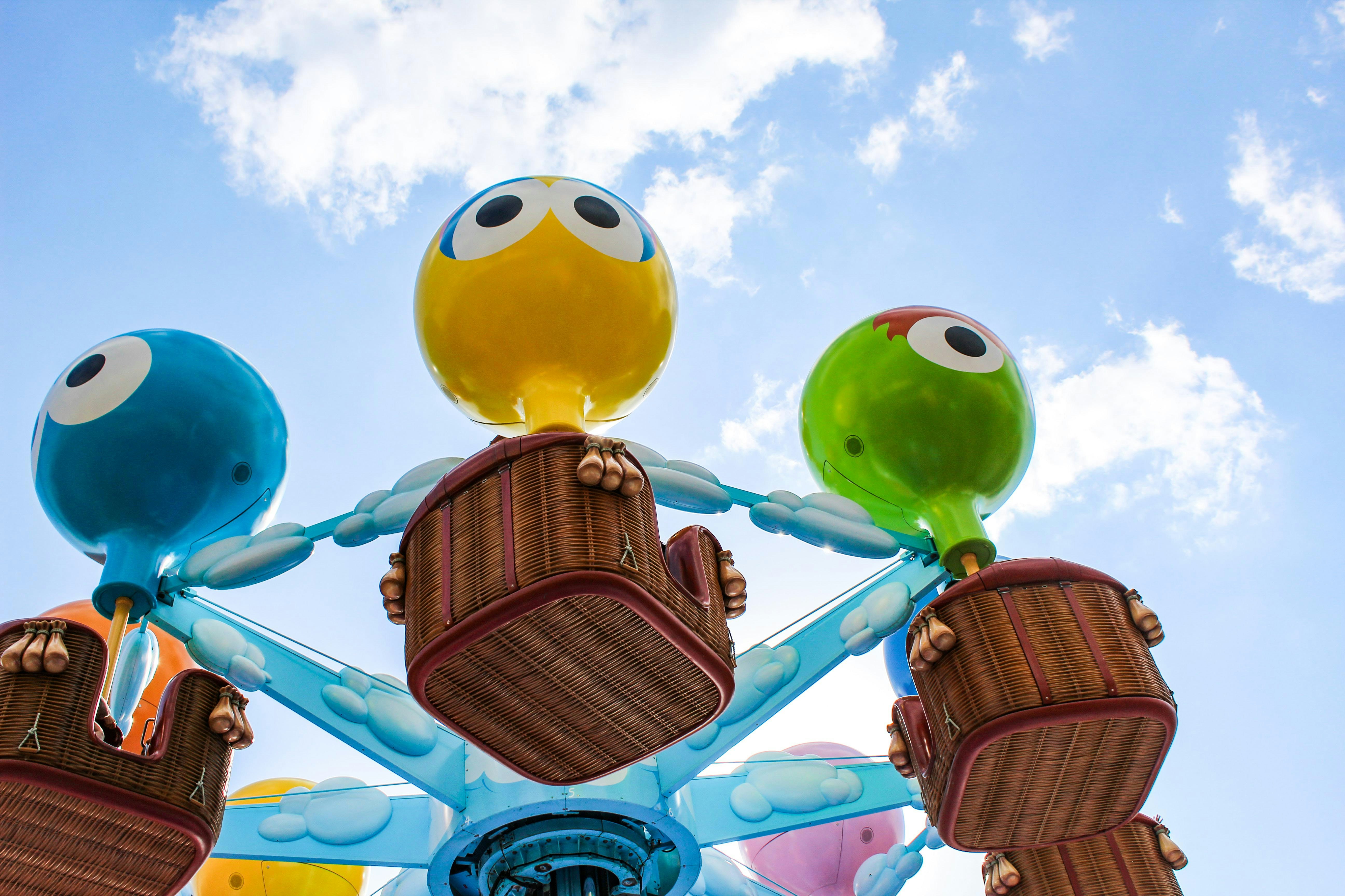 Colorful character-themed ride at Universal Studios Japan against blue sky.