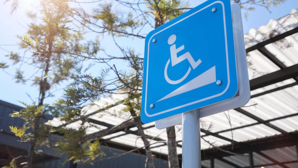 Wheelchair accessibility sign at 9/11 Memorial and Museum entrance.