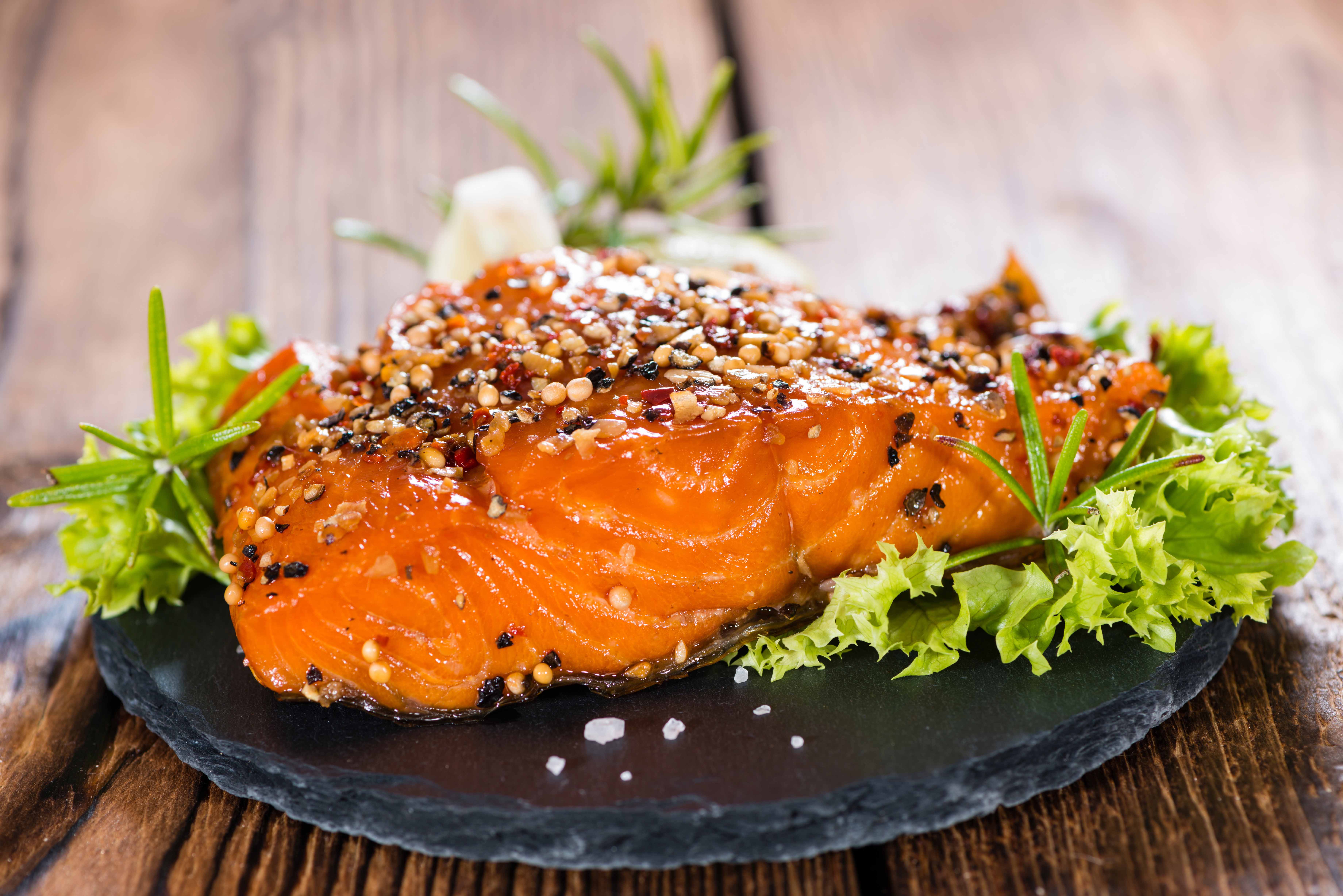 Grilled salmon with herbs and spices on a slate plate at Rafa Nadal Museum Xperience dining.