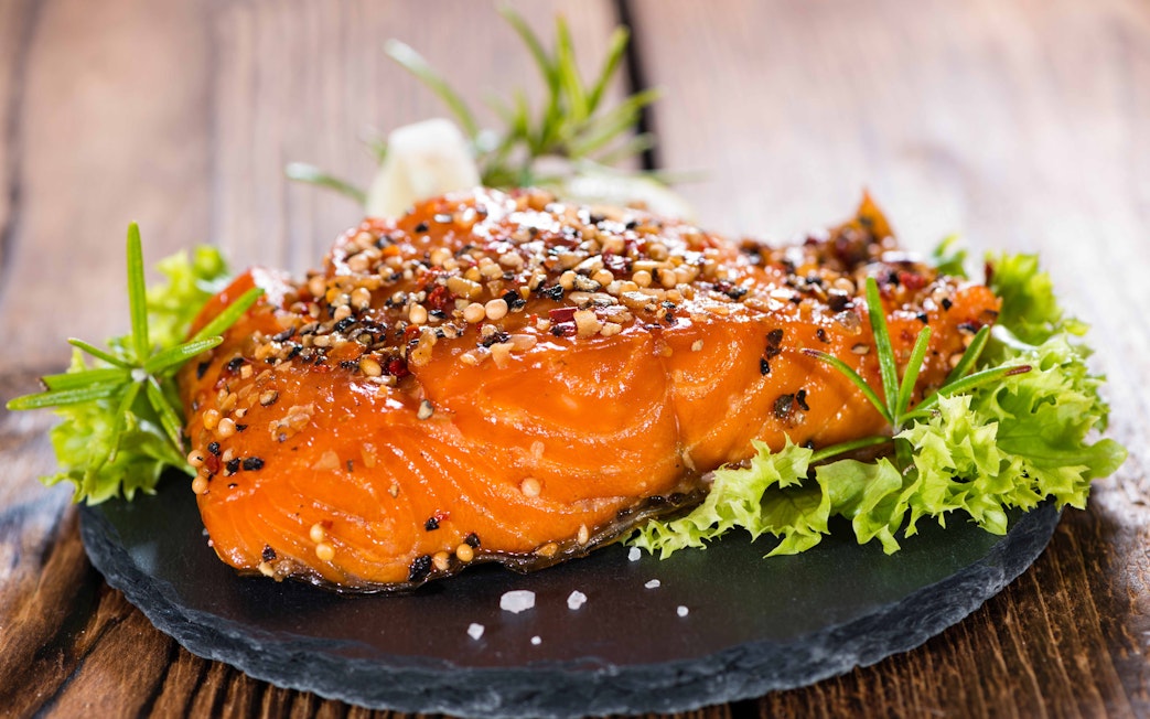 Grilled salmon with herbs and spices on a slate plate at Rafa Nadal Museum Xperience dining.