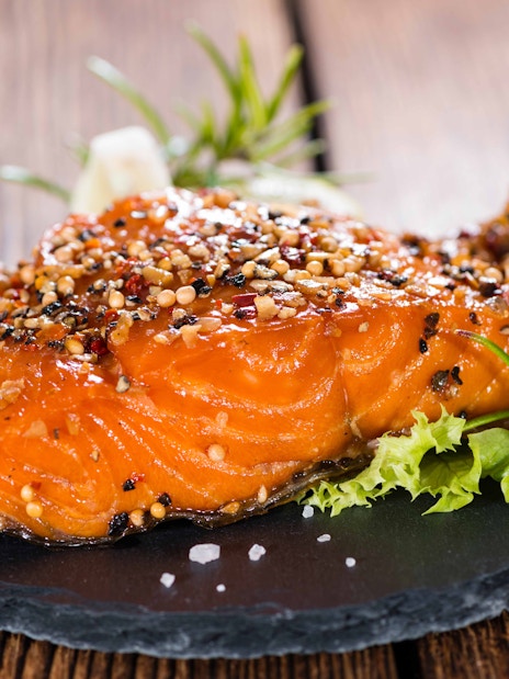 Grilled salmon with herbs and spices on a slate plate at Rafa Nadal Museum Xperience dining.