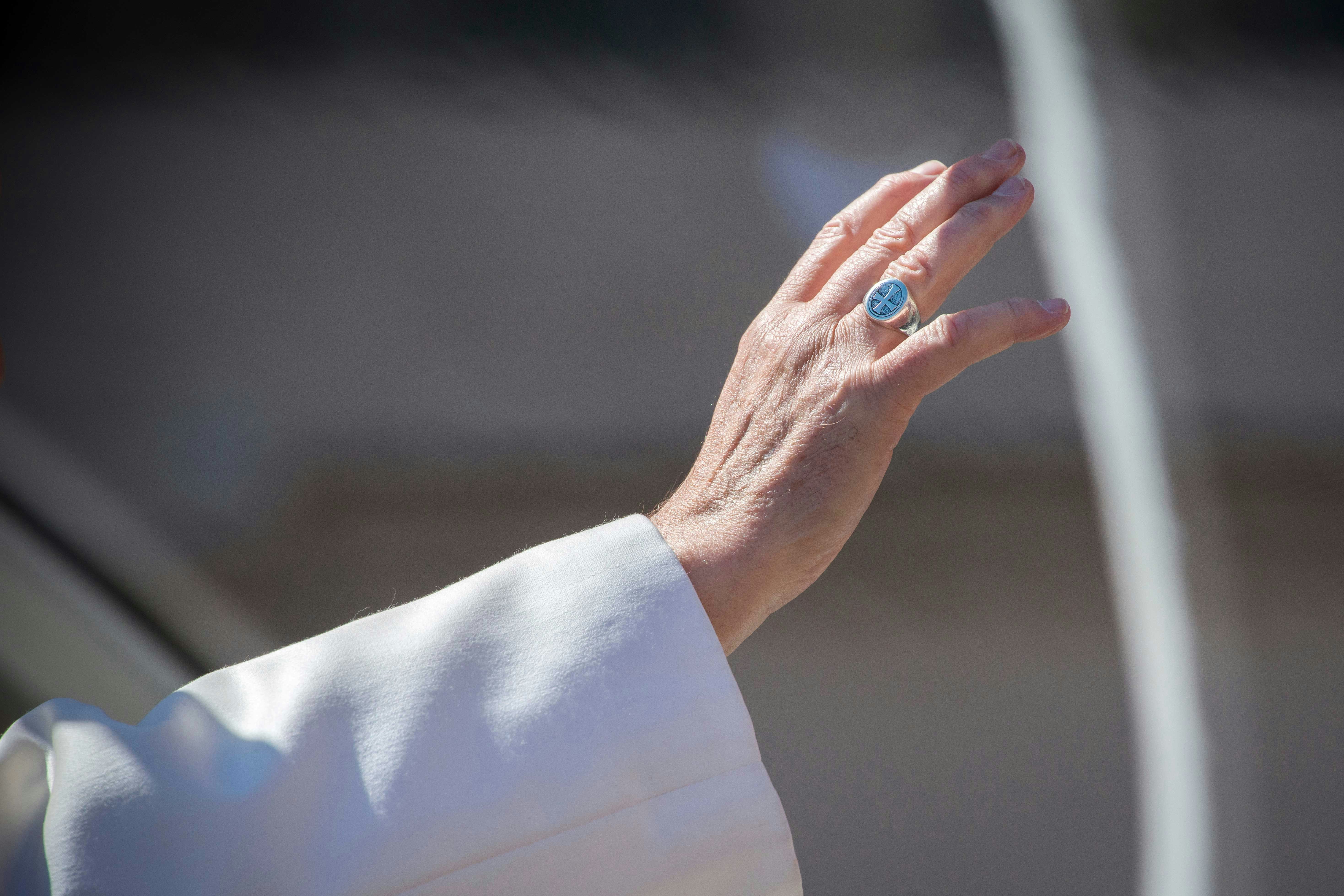 Hand raised in blessing during Christmas address in Rome.