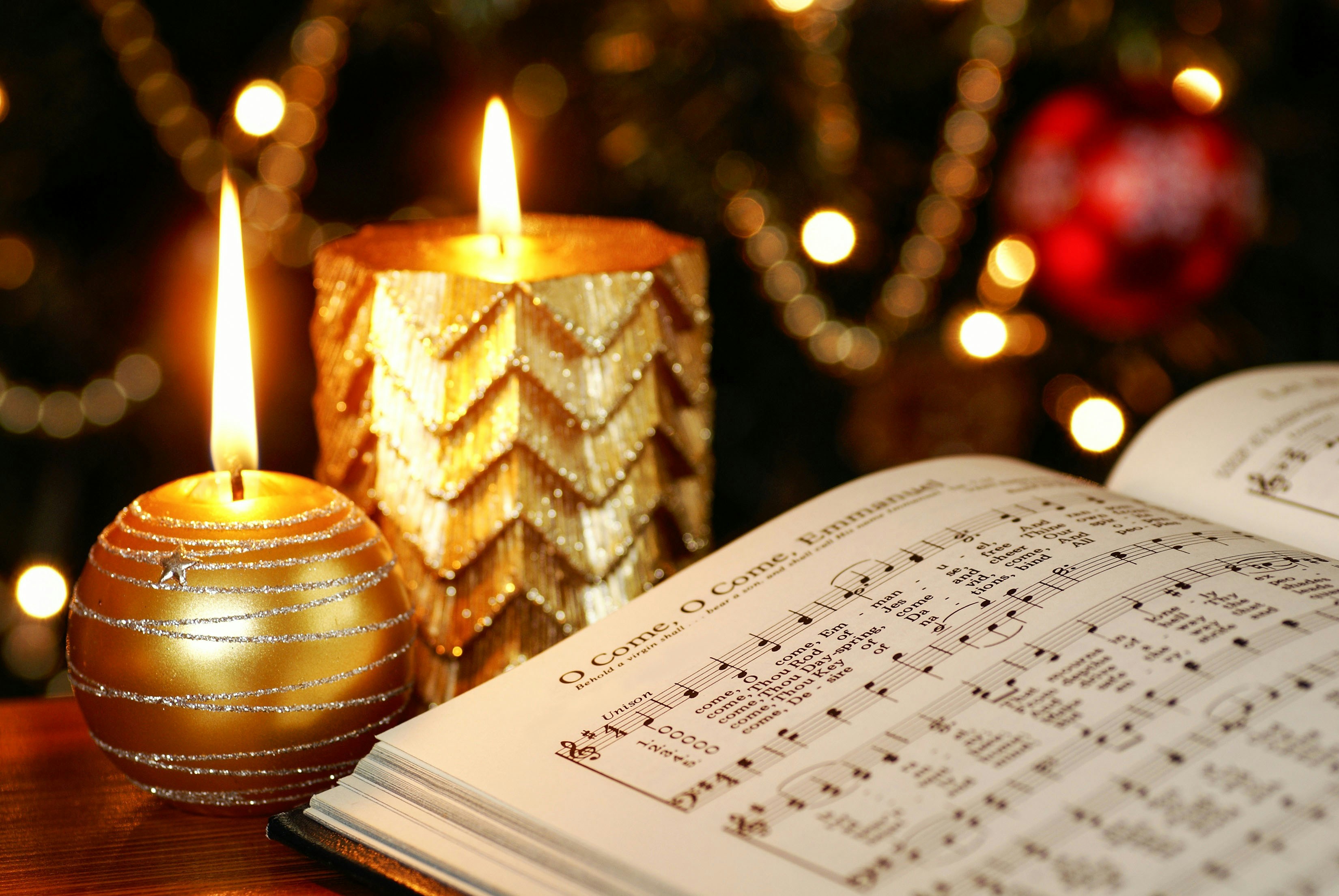 Christmas carol sheet music with lit candles in Amsterdam.