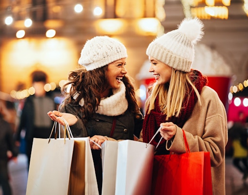 Shoppers with bags enjoying Christmas in Milan's high-end stores.
