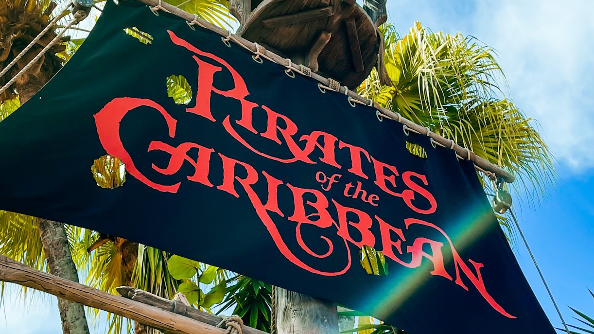 Pirates of the Caribbean ride at Disneyland Paris with pirate ship and tropical setting.