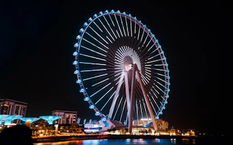 Ferris wheel illuminated at night on Bluewaters Island, Dubai.