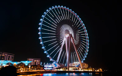 Ferris wheel illuminated at night on Bluewaters Island, Dubai.