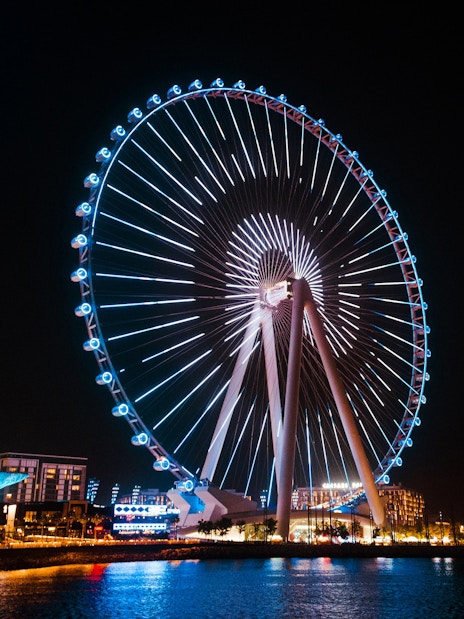 Ferris wheel illuminated at night on Bluewaters Island, Dubai.