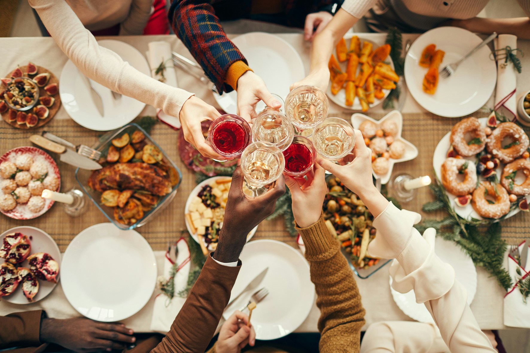 Toasting at a festive dinner table with various dishes.