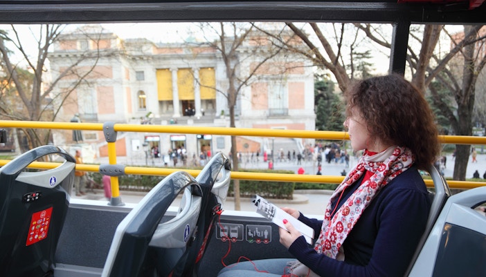 Young woman in tourist bus near Prado