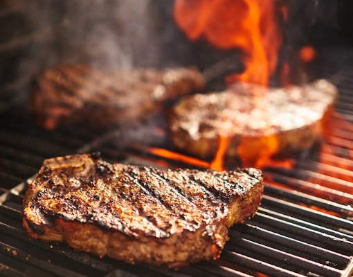 Grilled steaks on a barbecue at Silver Spur Steakhouse, Disneyland Paris.