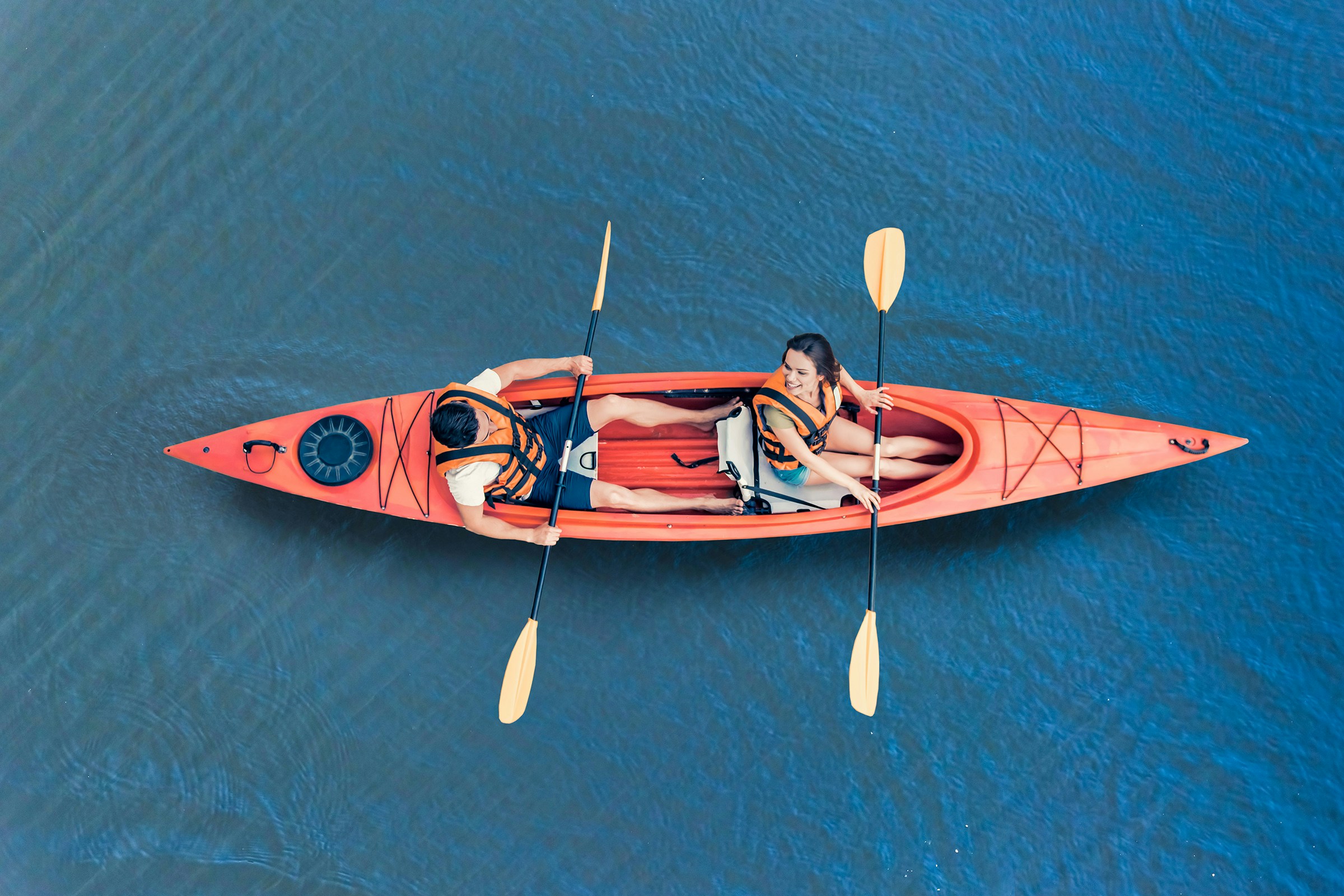 Kayakers paddling in clear waters near Moreton Island, Australia.