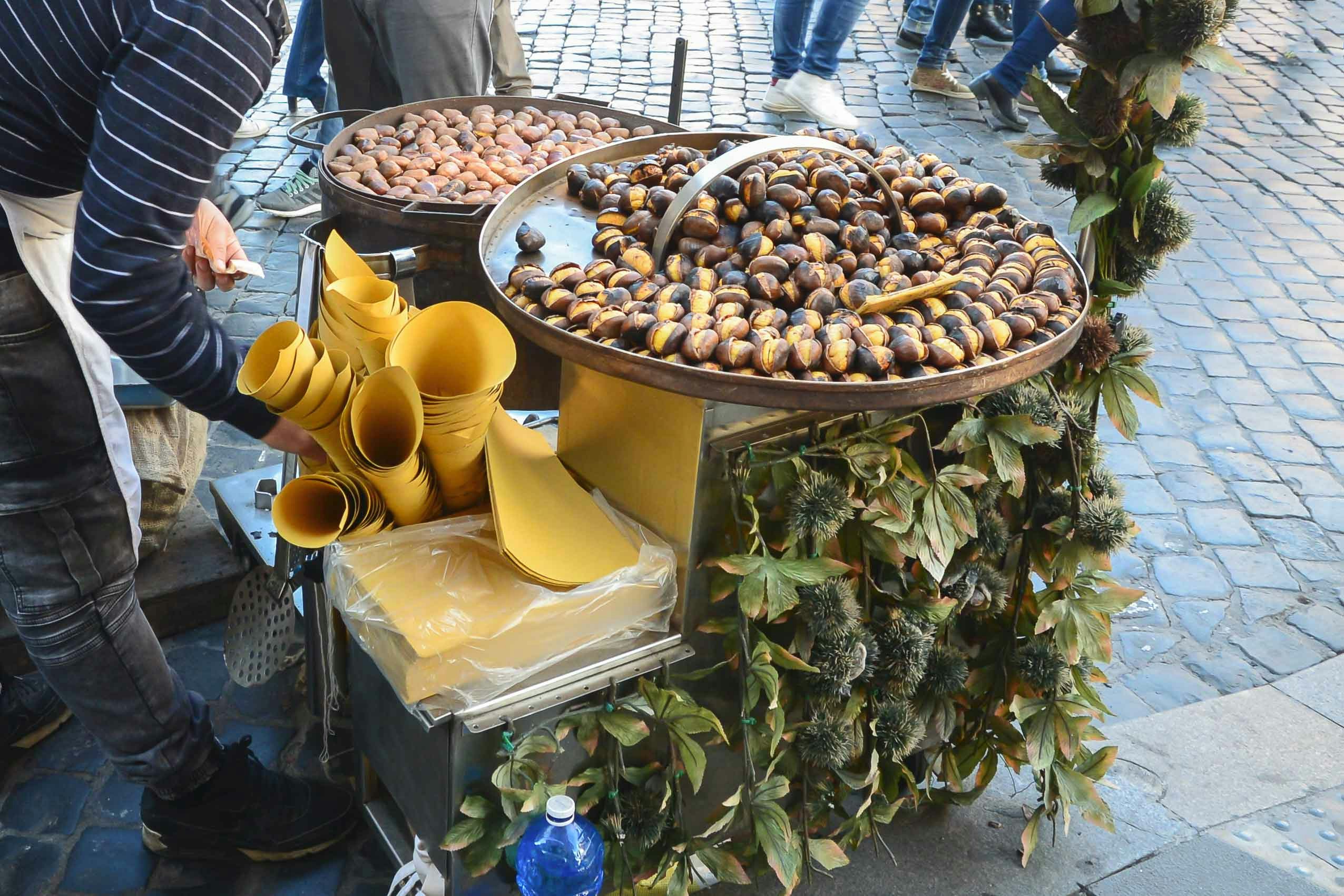 Street vendor selling roasted chestnuts in Rome during Christmas.
