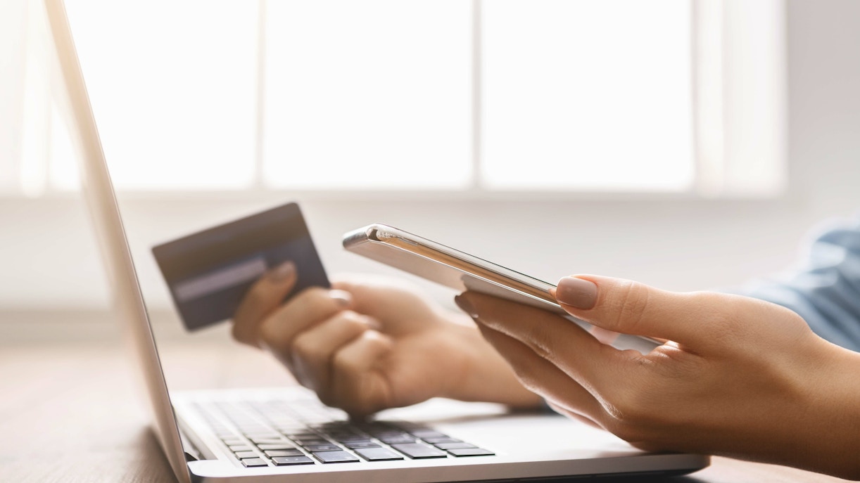 Close up of hands booking online tickets