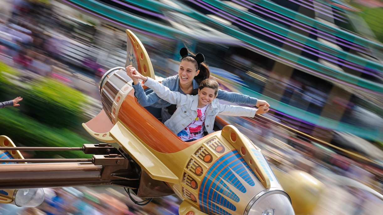 Orbitron ride at Disneyland Paris with futuristic spacecrafts in motion.