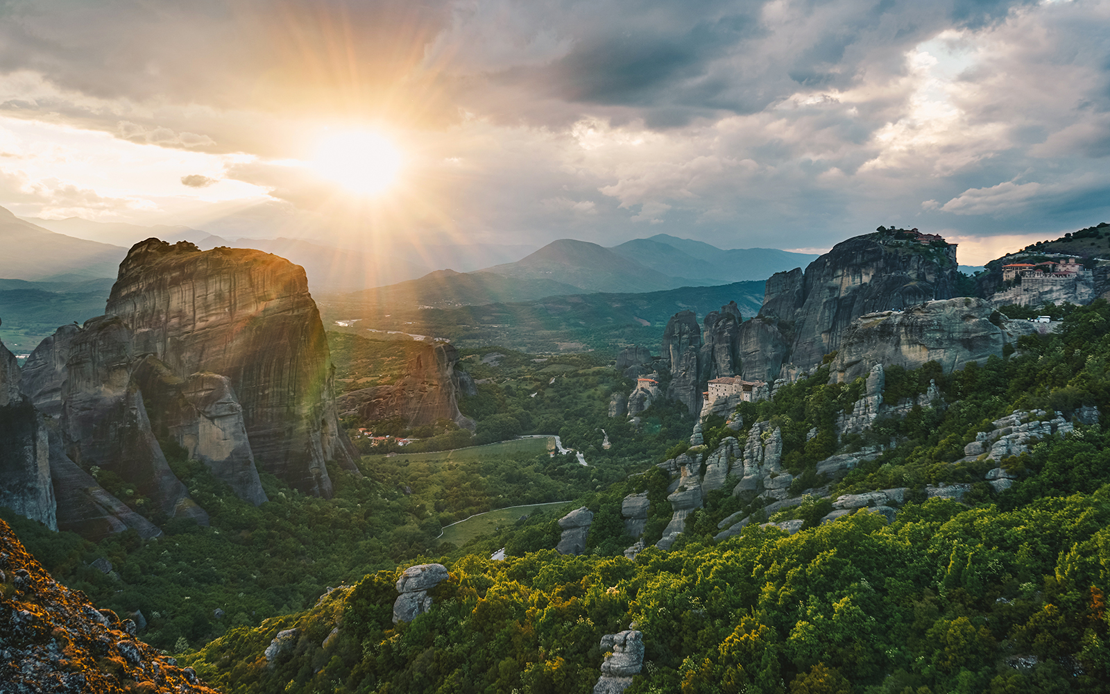 Meteora rock formations at sunset, Greece, highlighting hiking trails.