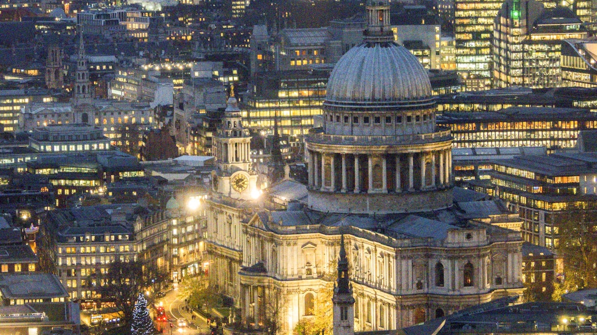 St Paul’s Cathedral dome illuminated at night in London cityscape.